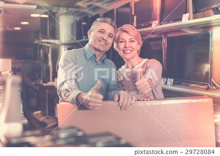 Mature couple are happy with choice and purchased consumer electronics Mature couple are happy with choice and purchased consumer electronics 29728084