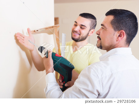Son and father drilling wall Son and father drilling wall 29728106