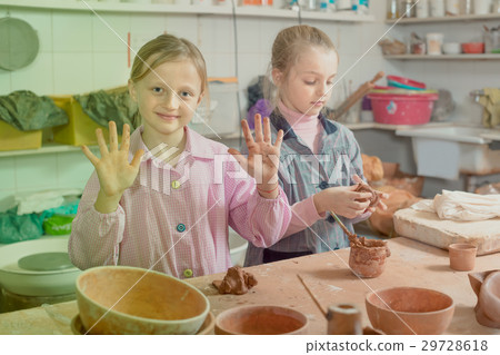 Smiling girls training to make ceramics during arts Smiling girls training to make ceramics during arts 29728618
