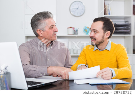 Adult man and agent discuss contract 29728732
