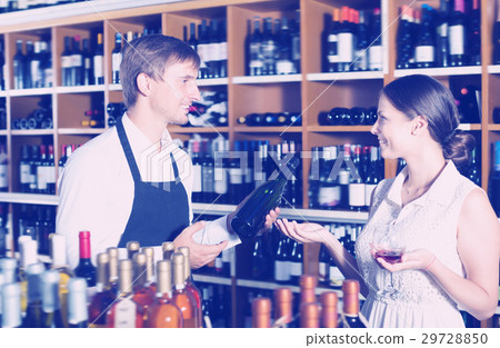 Happy seller man giving sample taste of wine Happy seller man giving sample taste of wine 29728850
