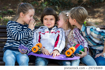 Kids sharing secrets as talking outdoor. 29728869