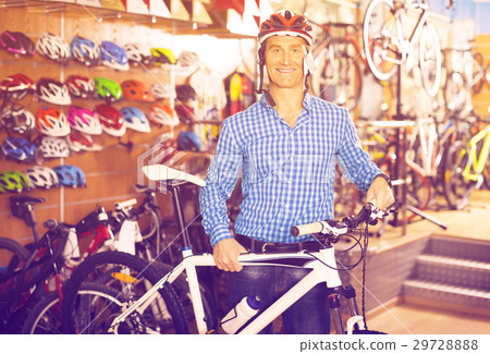 man choosing sport bike and helmet in store. 29728888
