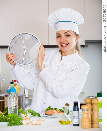 Female chef counting time down for cooling fish Female chef counting time down for cooling fish 29729042