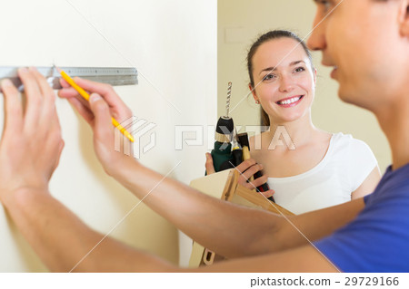 Couple makes repairs at home 29729166