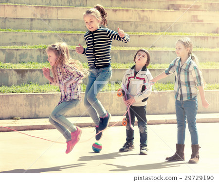 Young girl jumping while jump rope game 29729190