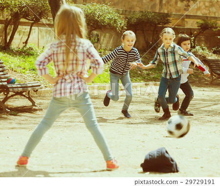Junior kids playing street football outdoors 29729191