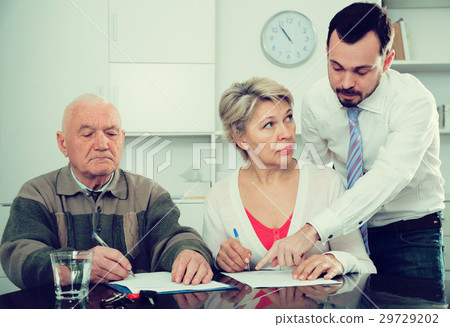 Woman and eldery man with bank employee 29729202