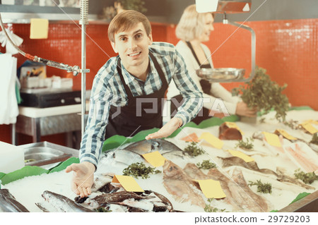 Sellers working in fish store 29729203