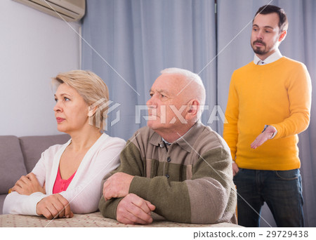 Man seriously talking with family 29729438