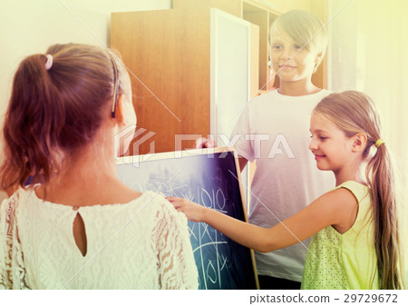kids playing at Tic-tac-toe in living room 29729672