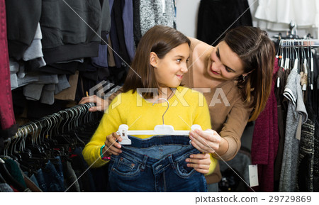 Teenage-girl with her mother are looking for jeans Teenage-girl with her mother are looking for jeans 29729869