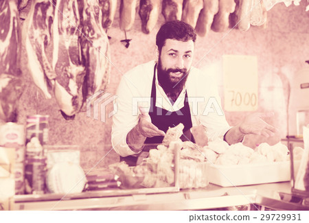 assistant demonstrating sorts of meat 29729931