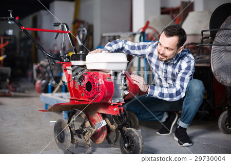 Person is starting to work with plough Person is starting to work with plough 29730004
