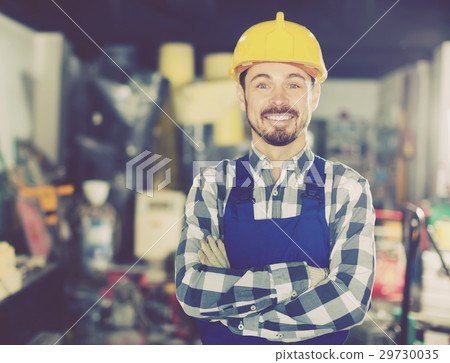 Smiling man displaying his workplace and tools 29730035