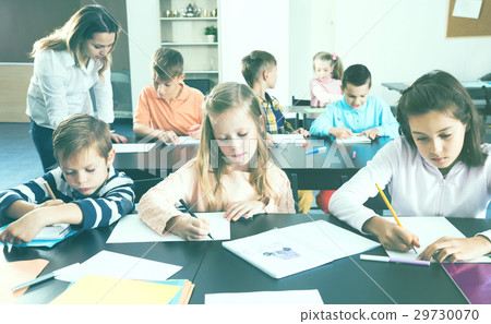 Little children with teacher in classroom 29730070