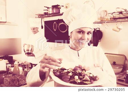 Female chef preparing fresh salad 29730205