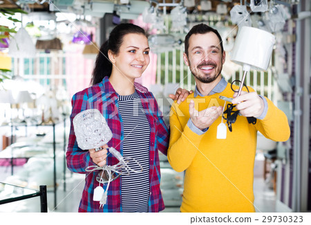 Couple decides to buy a table lamp 29730323