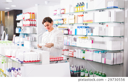 Woman is browsing rows of body care products 29730556