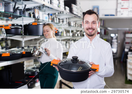 Adult couple deciding on best saucepan 29730574
