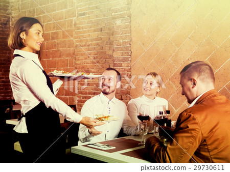 Female waiter carrying order for visitors 29730611