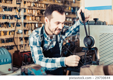 Male worker making key in specialized workshop - Stock Photo [29730644 ...