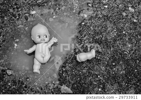 abandoned baby doll in the water on the road abandoned baby doll in the water on the road 29733911