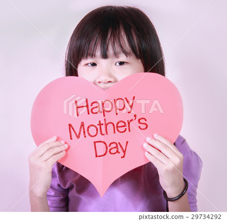 A cute little girl holding a heart shape paper. 29734292