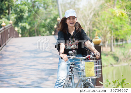 young asian woman/traveller with riding road bike young asian woman/traveller with riding road bike 29734967