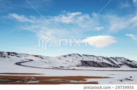 Landscaped in winter with country road  29739958