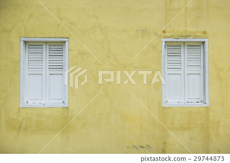 Wooden white windows on yellow wall background 29744873