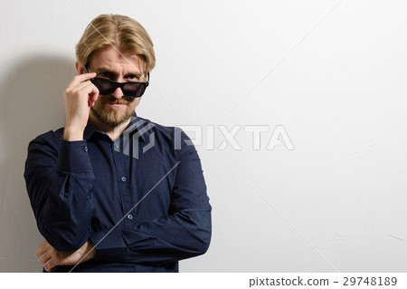 Stylish man in blue shirt and sunglasses standing Stylish man in blue shirt and sunglasses standing 29748189