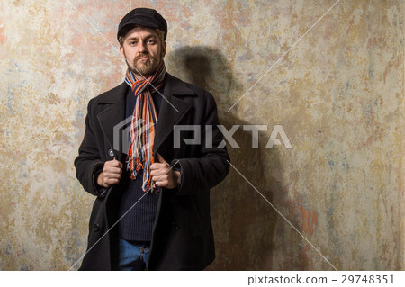 man with grungy blond hair dressed warmly 29748351