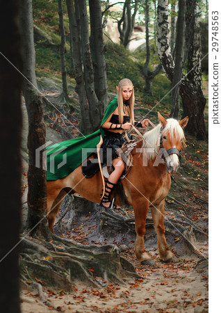 Female elf in the forest with her horse  29748563