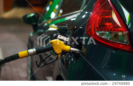 Car refueling on a petrol station at night 29748980