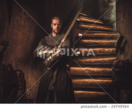 Medieval knight in ancient castle interior. 29749564