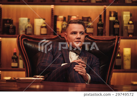 Confident upper class man with glass of beverage Confident upper class man with glass of beverage 29749572