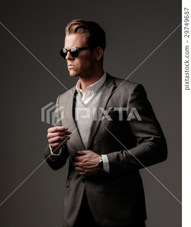 Confident sharp dressed man in grey jacket. 29749687