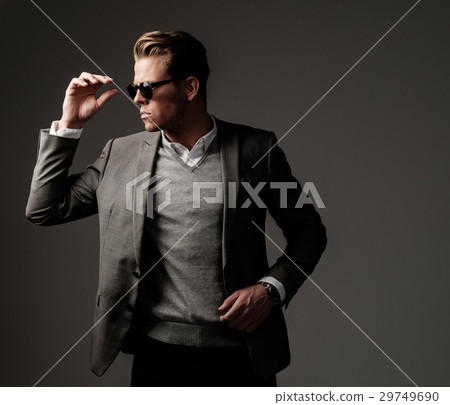 Confident sharp dressed man in grey jacket. Confident sharp dressed man in grey jacket. 29749690