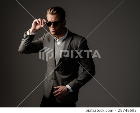 Confident sharp dressed man in grey jacket. 29749692
