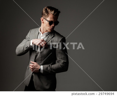 Confident sharp dressed man in grey jacket. 29749694