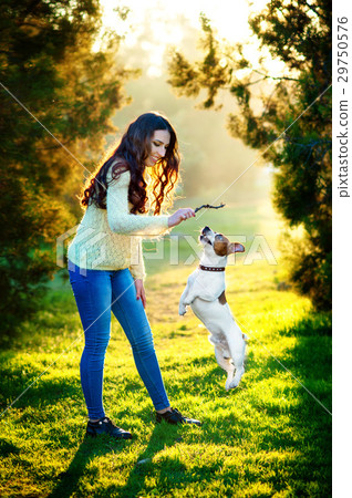 Young woman walking with a dog playing training Young woman walking with a dog playing training 29750576