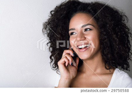 Portrait of a smiling woman talking on her phone Portrait of a smiling woman talking on her phone 29750588