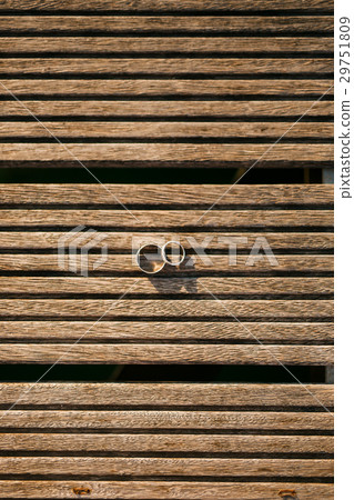 Wedding rings on a light wooden texture Wedding rings on a light wooden texture 29751809