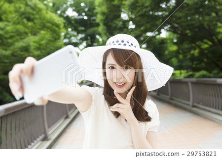 Young woman smartphone self-shooting camera looking face smile Young woman smartphone self-shooting camera looking face smile 29753821
