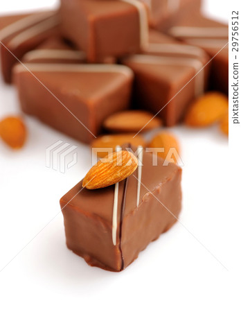 Chocolate praline with almonds on white background Chocolate praline with almonds on white background 29756512