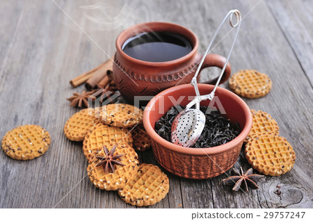 A cup of hot tea with cookies on wooden background A cup of hot tea with cookies on wooden background 29757247