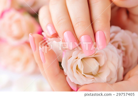 Hands of a woman with pink manicure on nails 29757405