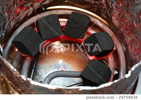 Coconut charcoal for hookah on hot spiral. 29758916