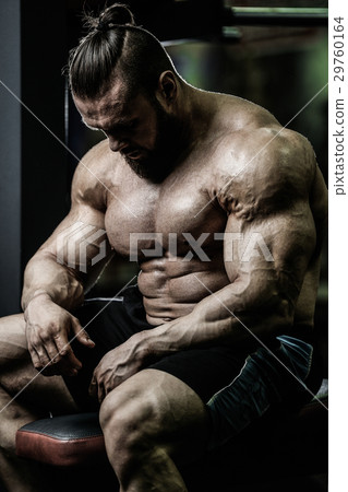 Handsome athletic man training pumping up muscles 29760164